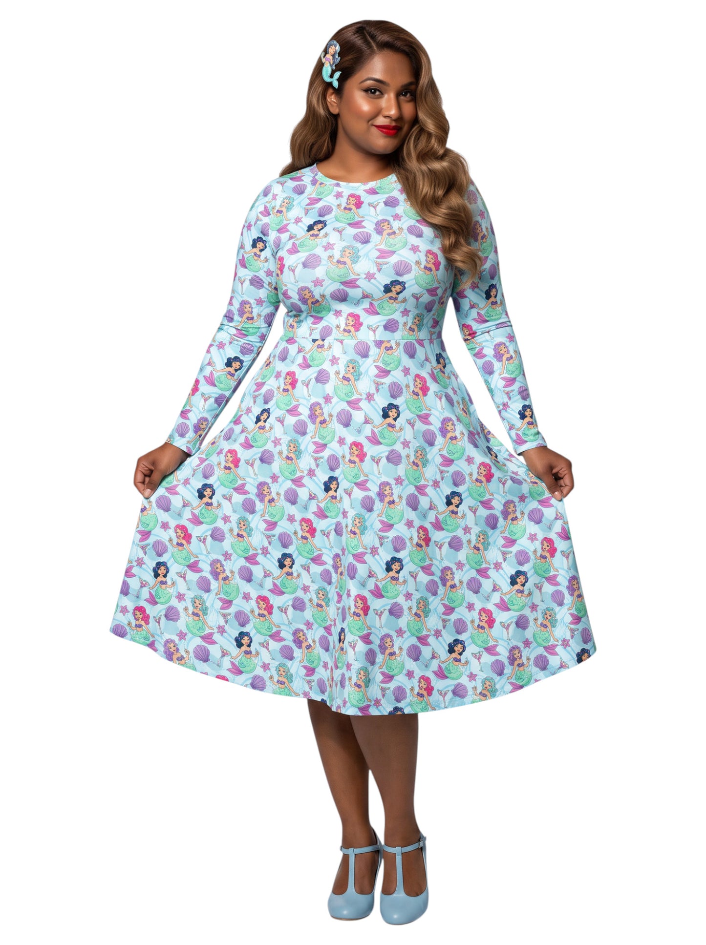 Plus size woman wearing light blue Mermaids and Martinis long sleeve pinup dress with pockets