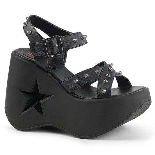 Black vegan leather platform wedge sandals with star cutout heel, silver cone spikes, and criss-cross ankle straps