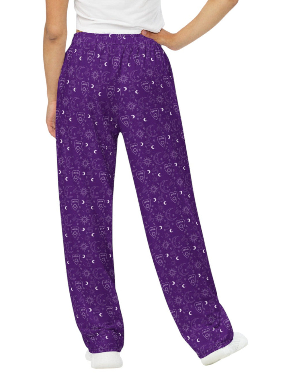 Woman wearing purple Whimsigoth wide leg lounge pants with celestial moon and sun print.