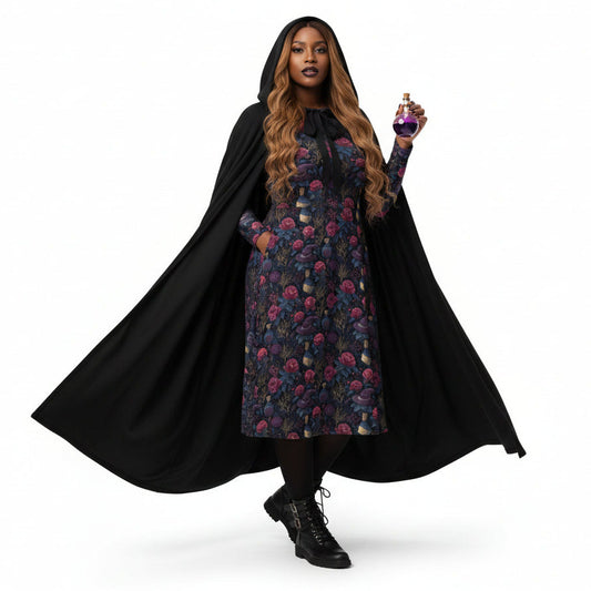 Person wearing a black cape over a floral dress, holding a scepter on a white background