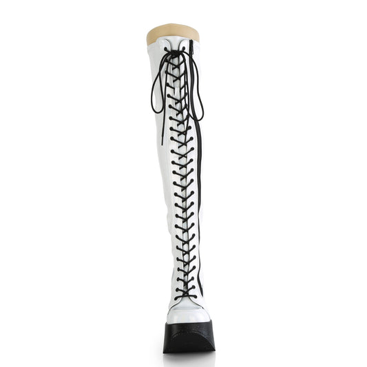 White holographic thigh-high platform boots with black laces and 5-inch star cutout wedge heel.