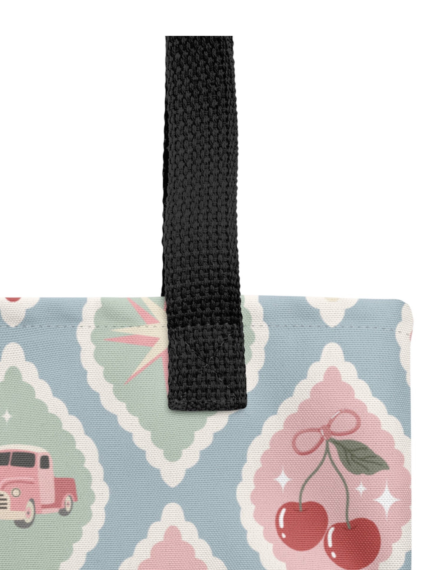 1950s diner retro tote bag with pastel pinup pattern featuring cherries, milkshakes, and jukeboxes on a light blue background with black straps.