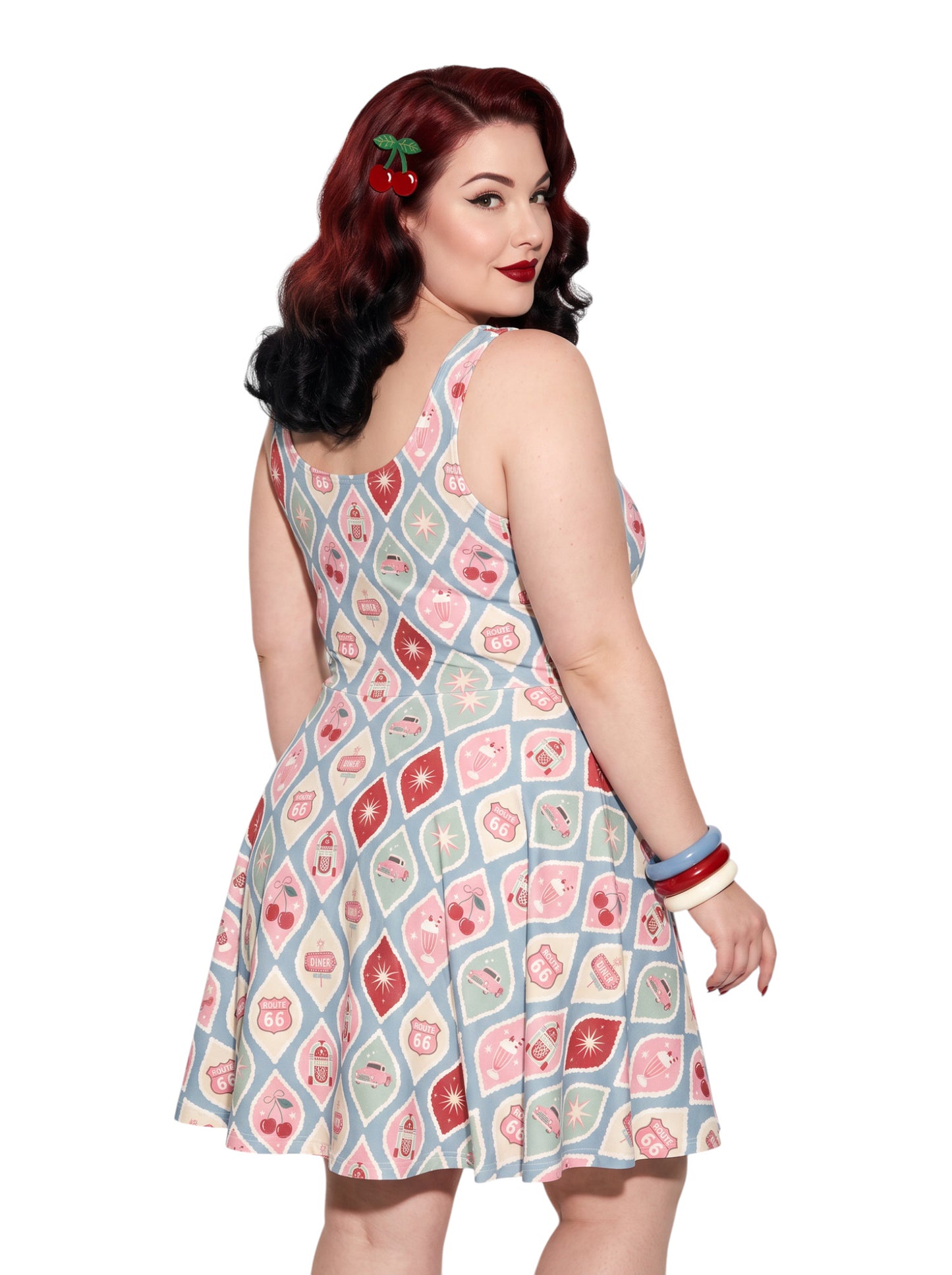 Plus size pinup woman wearing a 1950s style cherry diner milkshake pattern swing dress made of high stretch fabric