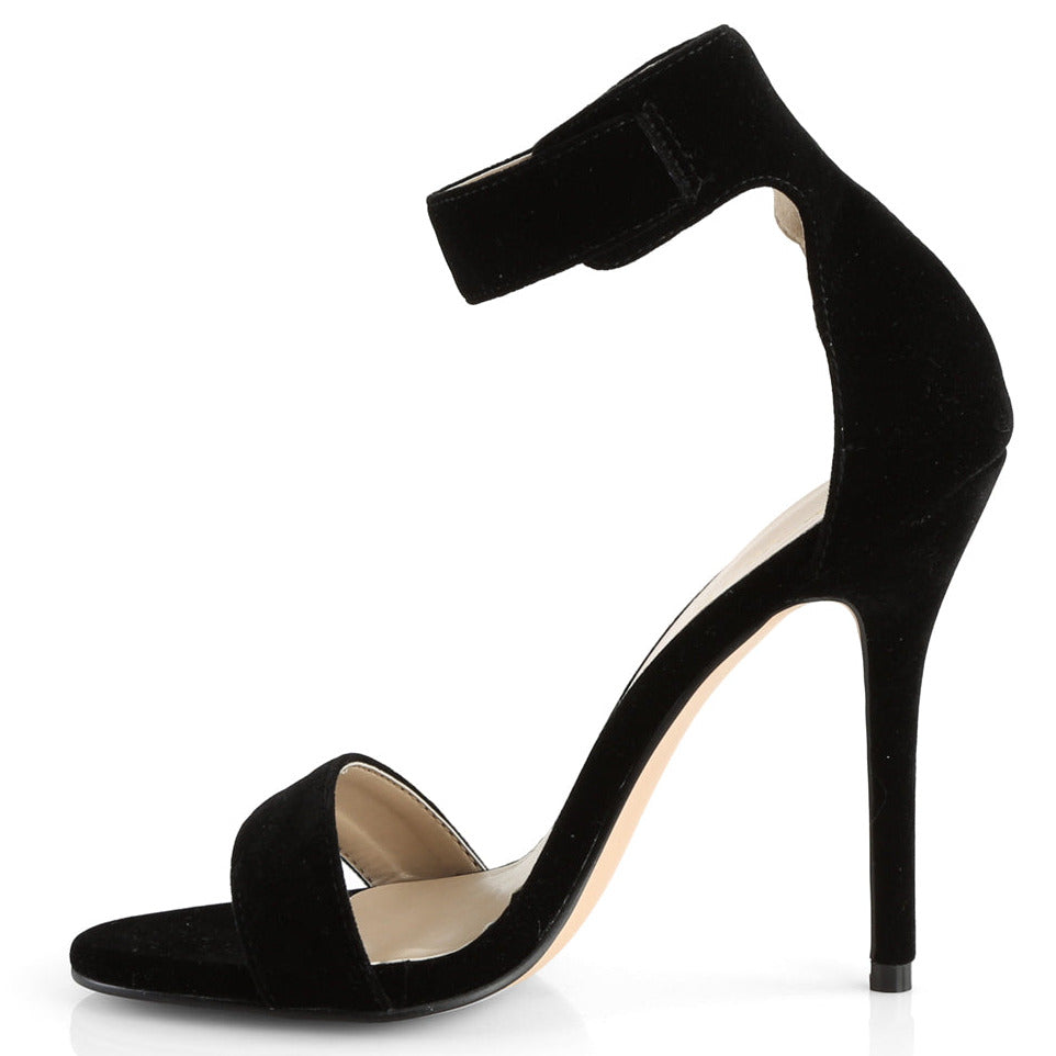 Black velvet ankle strap stiletto heel shoes on a white background