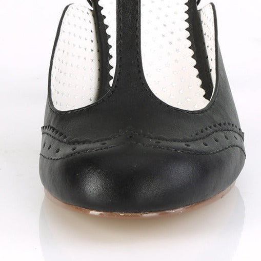 Black high-heeled shoe with a white sole on a white background