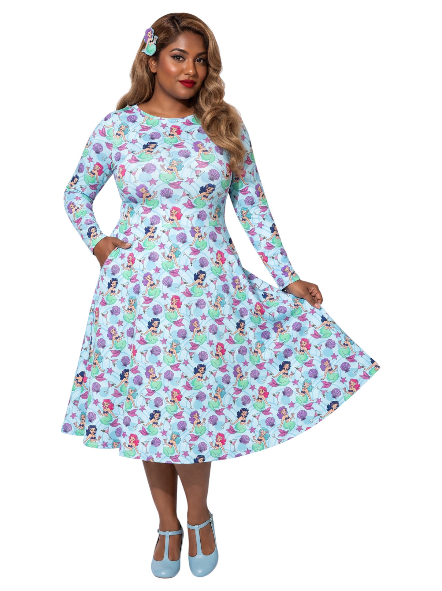 Plus size woman wearing light blue Mermaids and Martinis long sleeve pinup dress with pockets