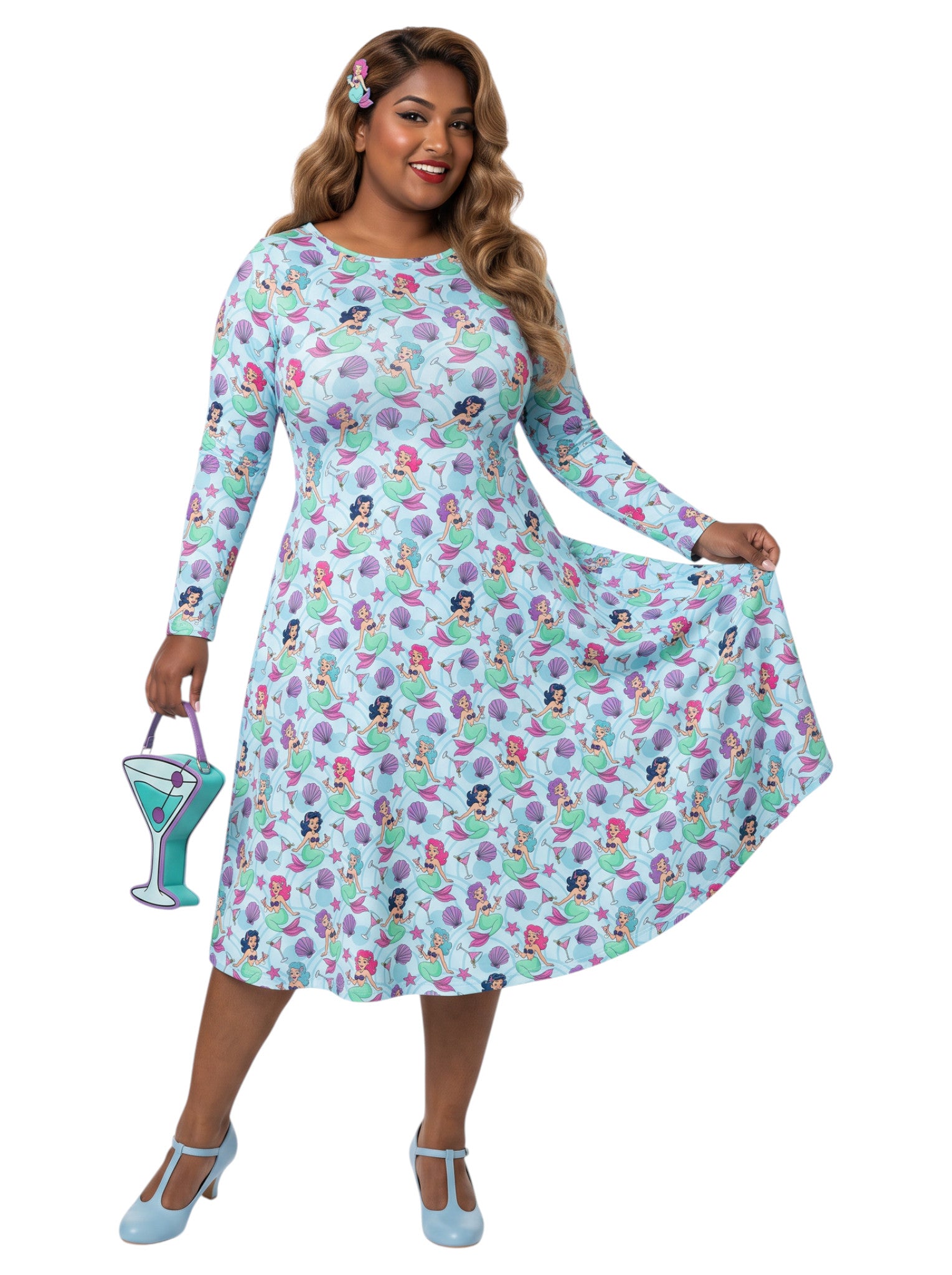 Plus size woman wearing light blue Mermaids and Martinis long sleeve pinup dress with pockets