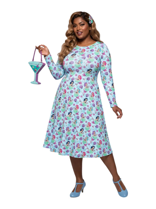 Plus size woman wearing light blue Mermaids and Martinis long sleeve pinup dress with pockets