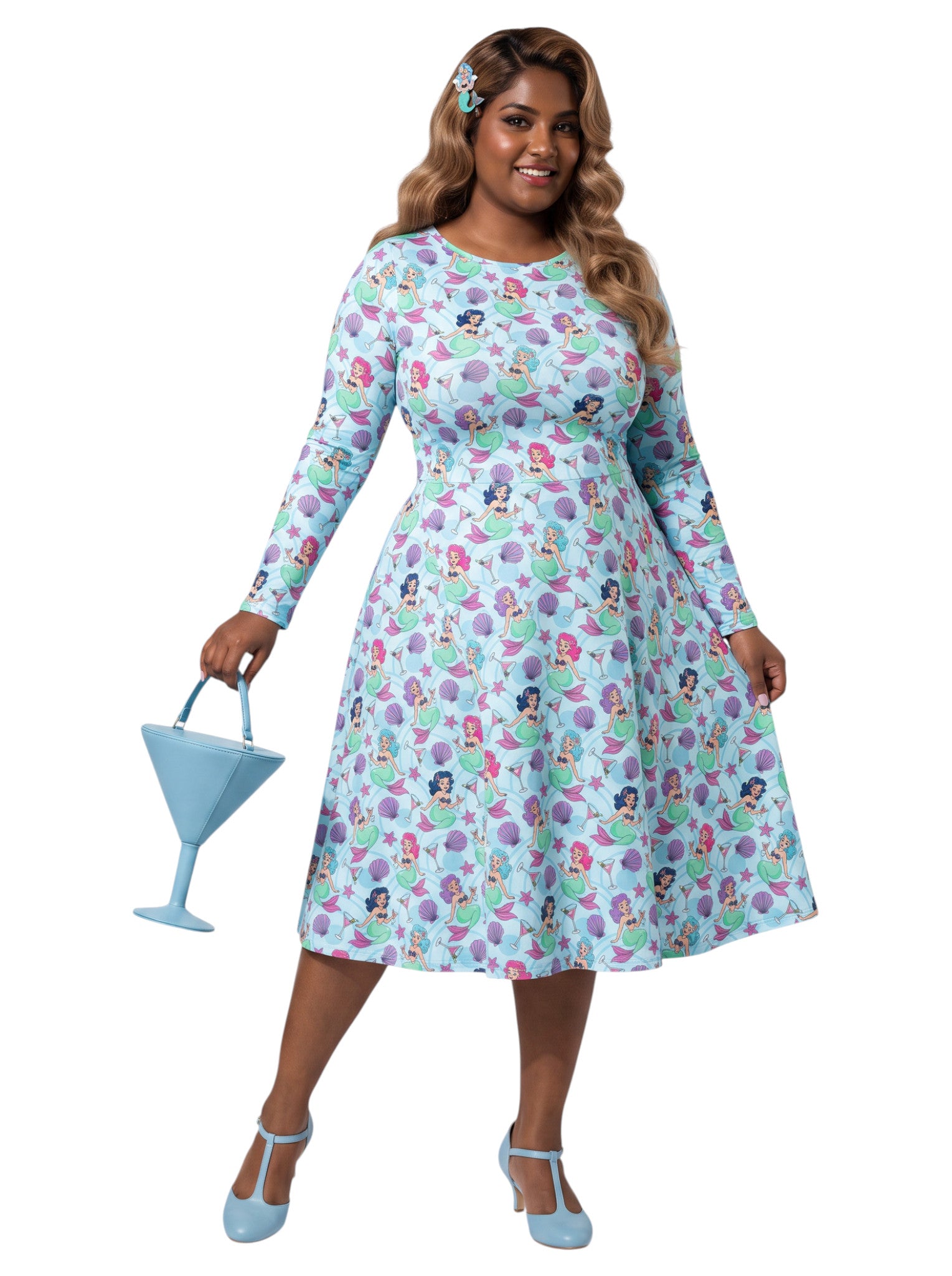 Plus size woman wearing light blue Mermaids and Martinis long sleeve pinup dress with pockets