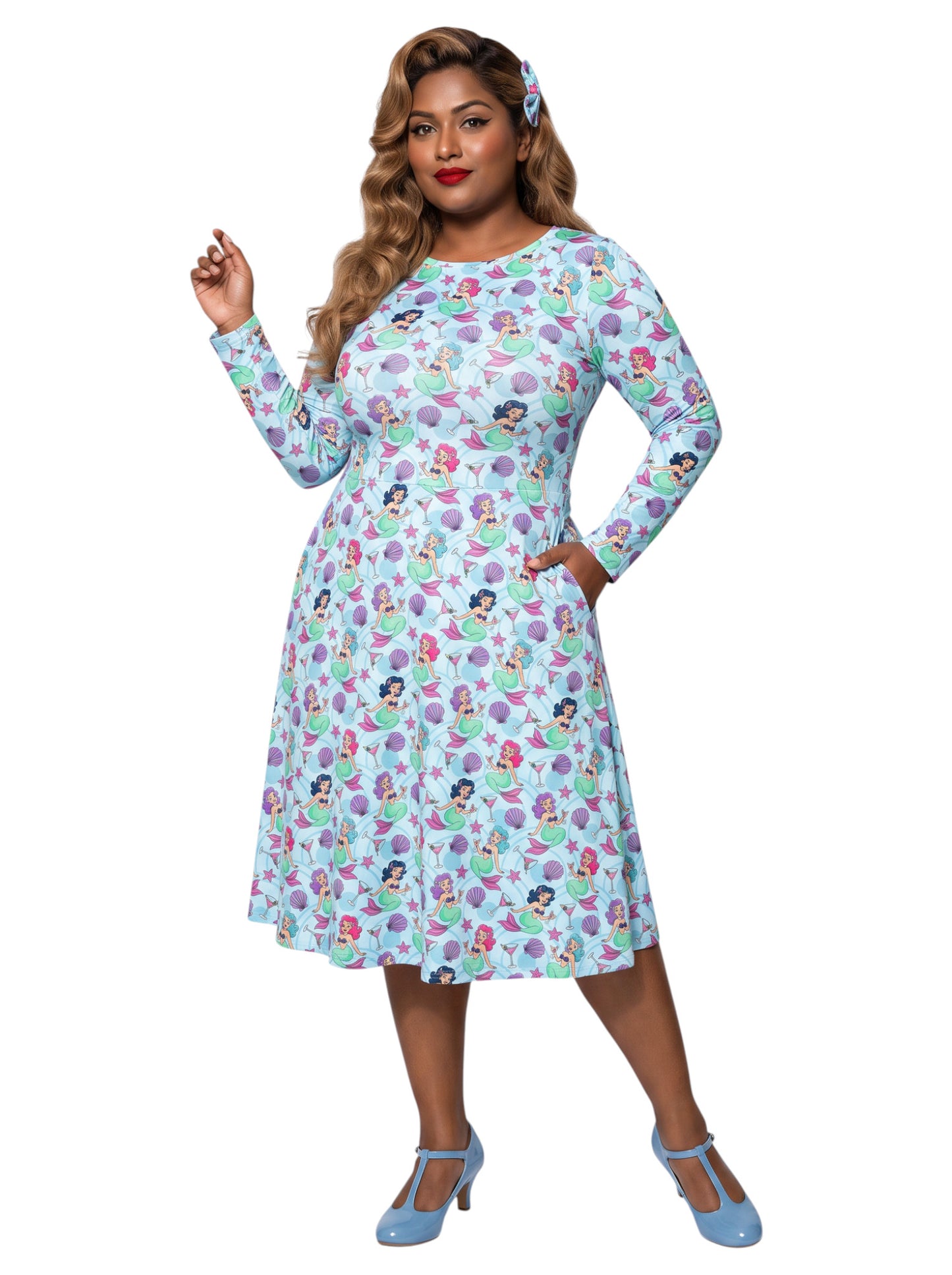 Plus size woman wearing light blue Mermaids and Martinis long sleeve pinup dress with pockets