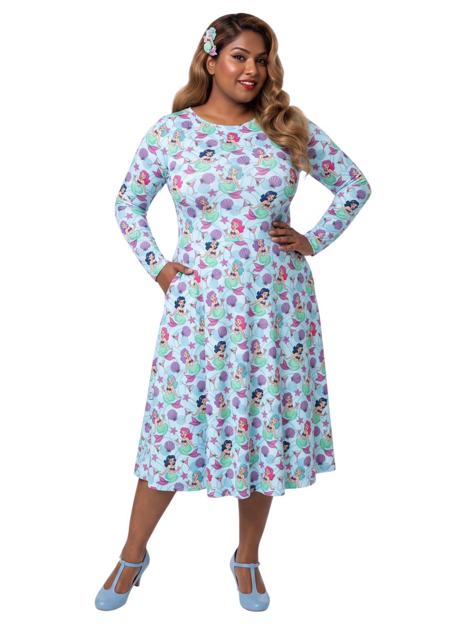 Plus size woman wearing light blue Mermaids and Martinis long sleeve pinup dress with pockets