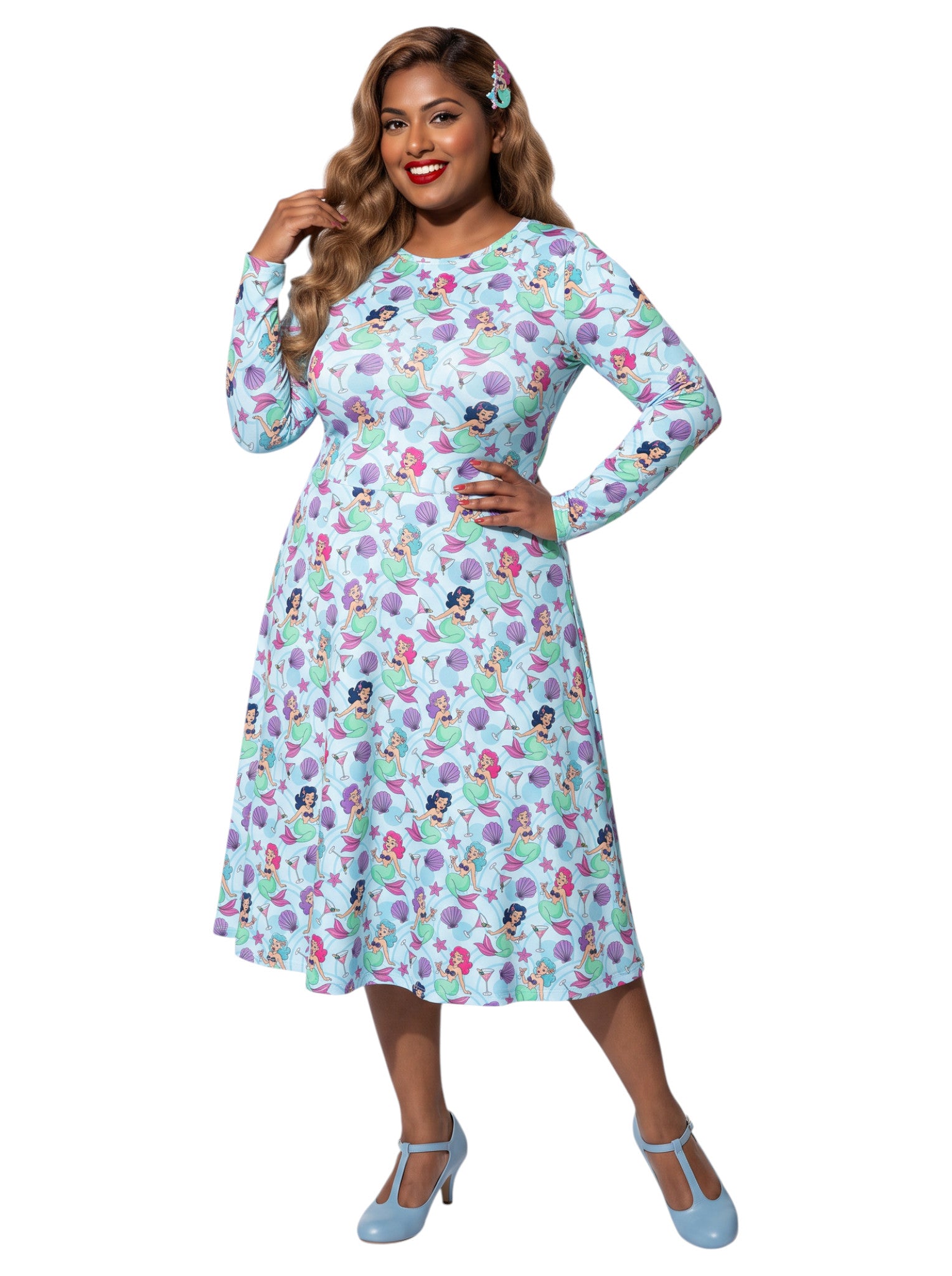 Plus size woman wearing light blue Mermaids and Martinis long sleeve pinup dress with pockets