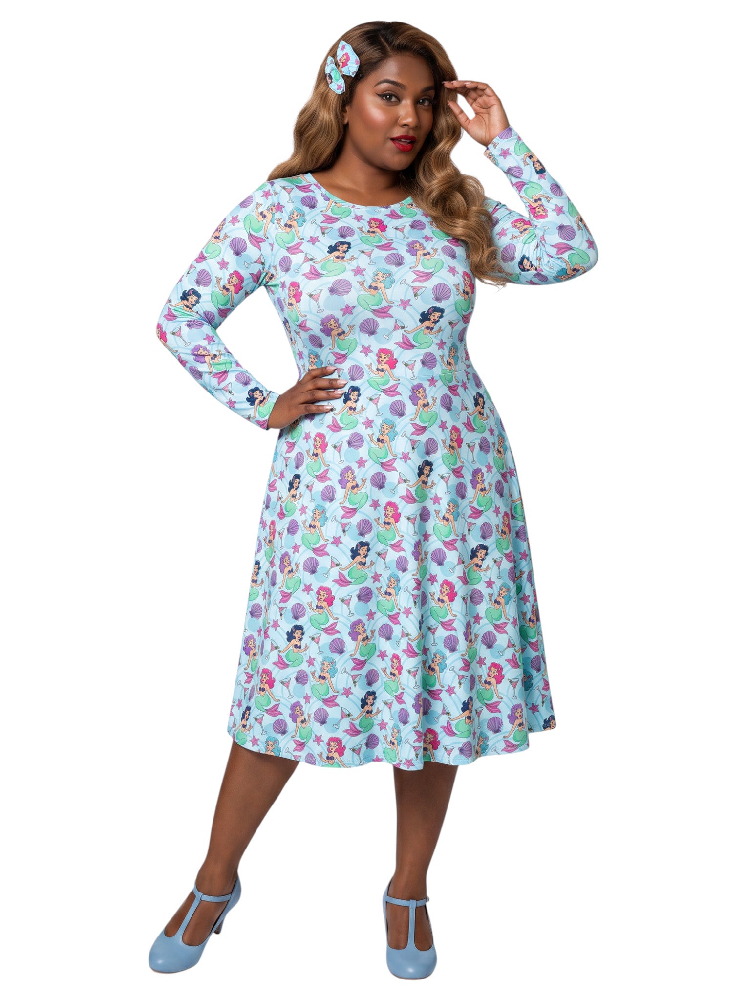 Plus size woman wearing light blue Mermaids and Martinis long sleeve pinup dress with pockets