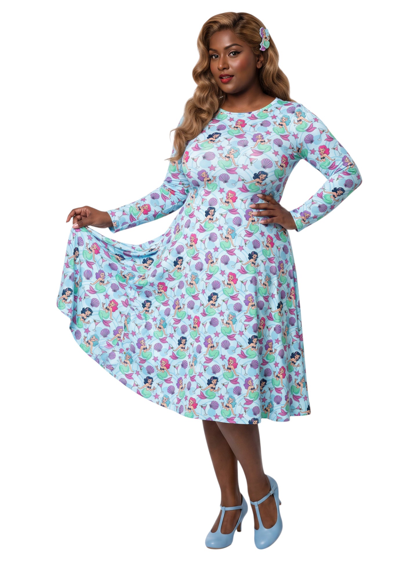 Plus size woman wearing light blue Mermaids and Martinis long sleeve pinup dress with pockets