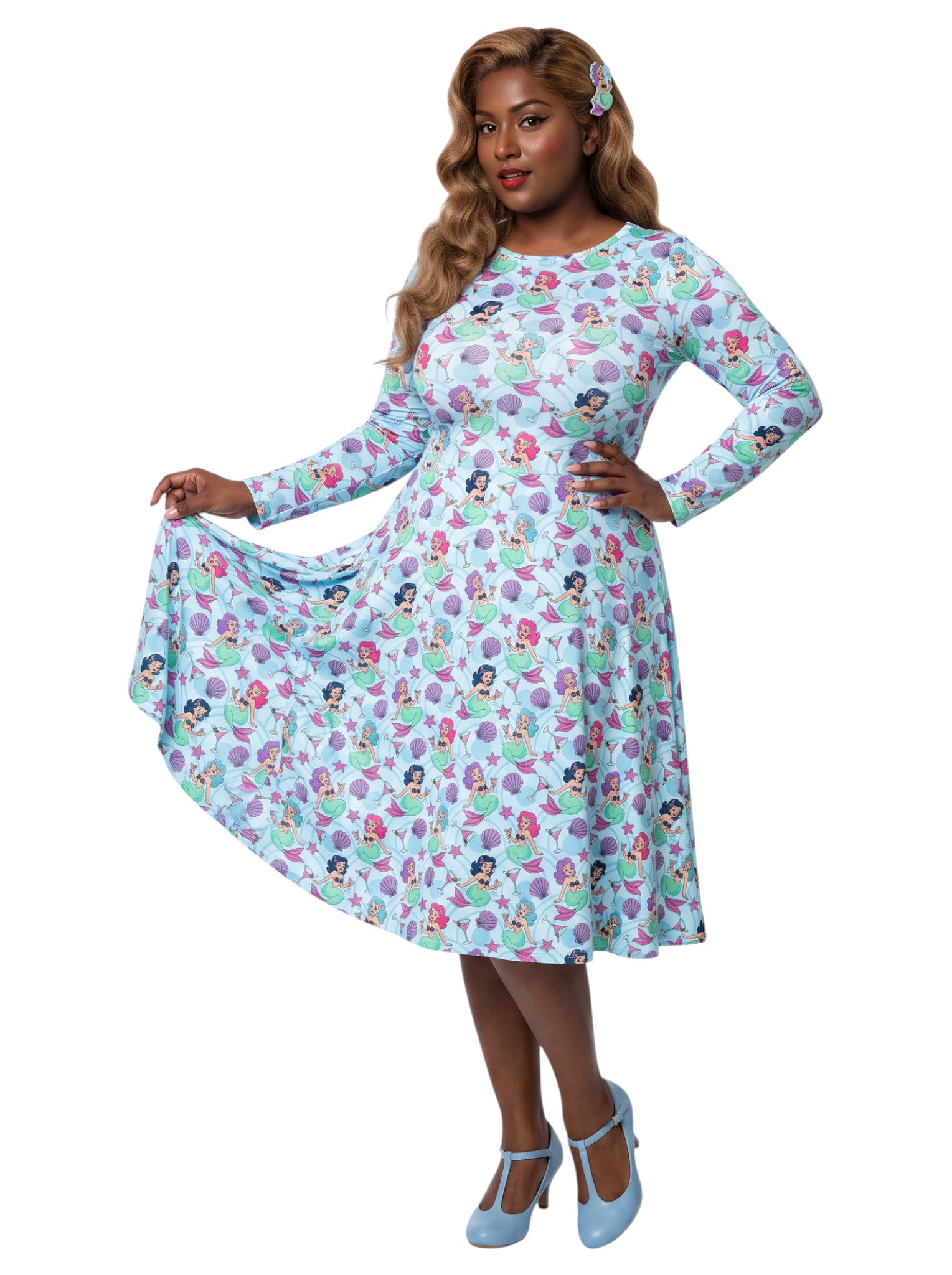 Plus size woman wearing light blue Mermaids and Martinis long sleeve pinup dress with pockets