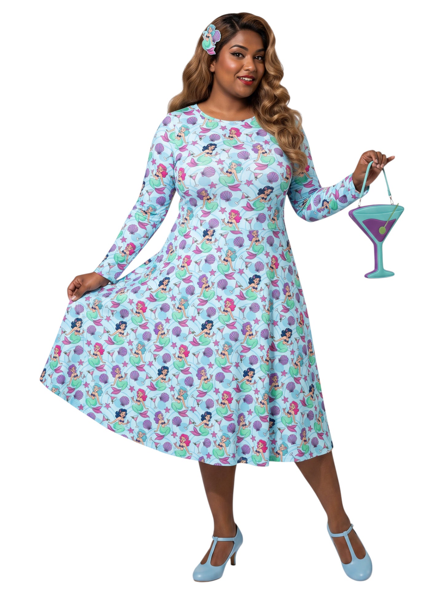 Plus size woman wearing light blue Mermaids and Martinis long sleeve pinup dress with pockets
