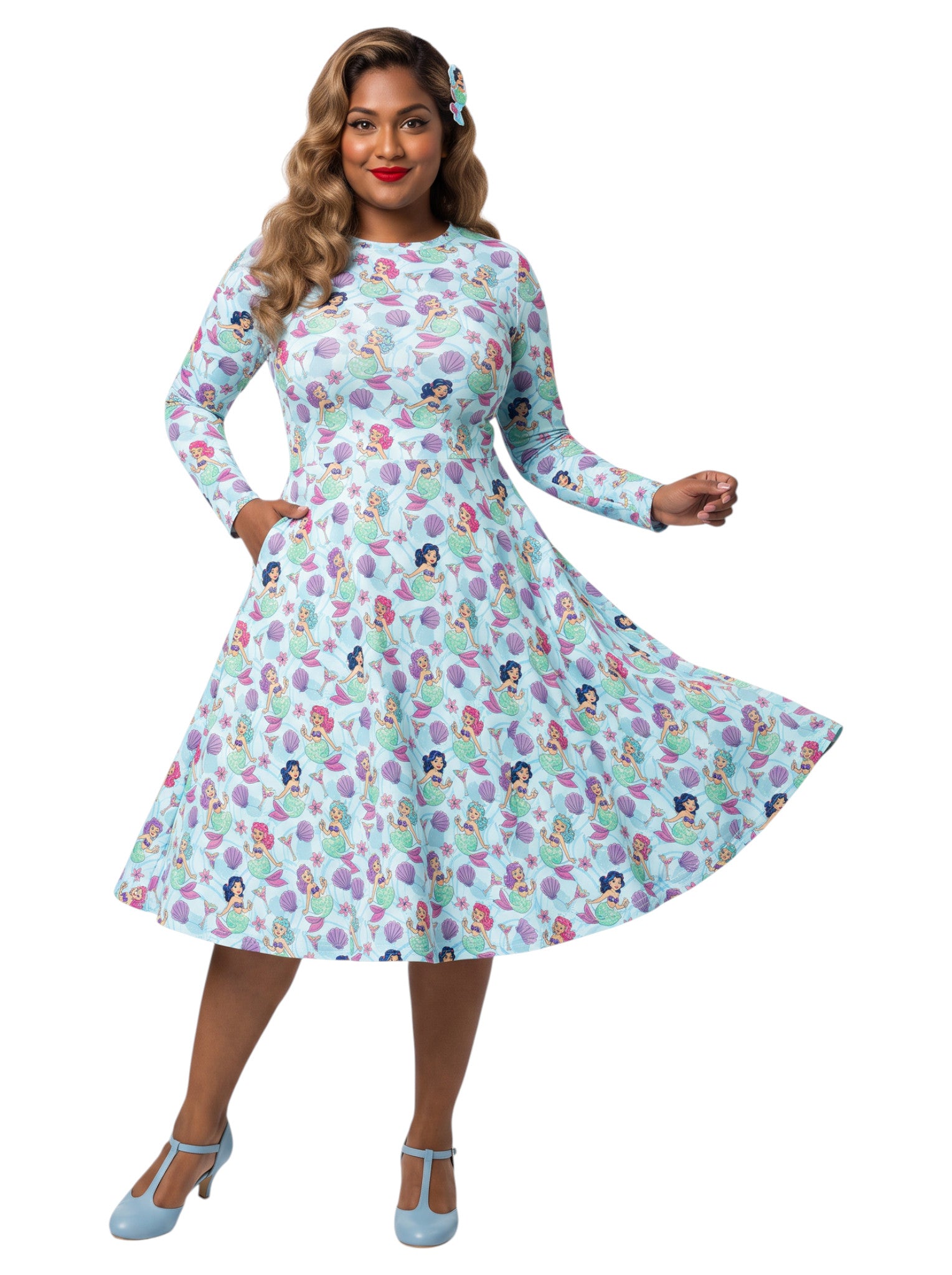 Plus size woman wearing light blue Mermaids and Martinis long sleeve pinup dress with pockets