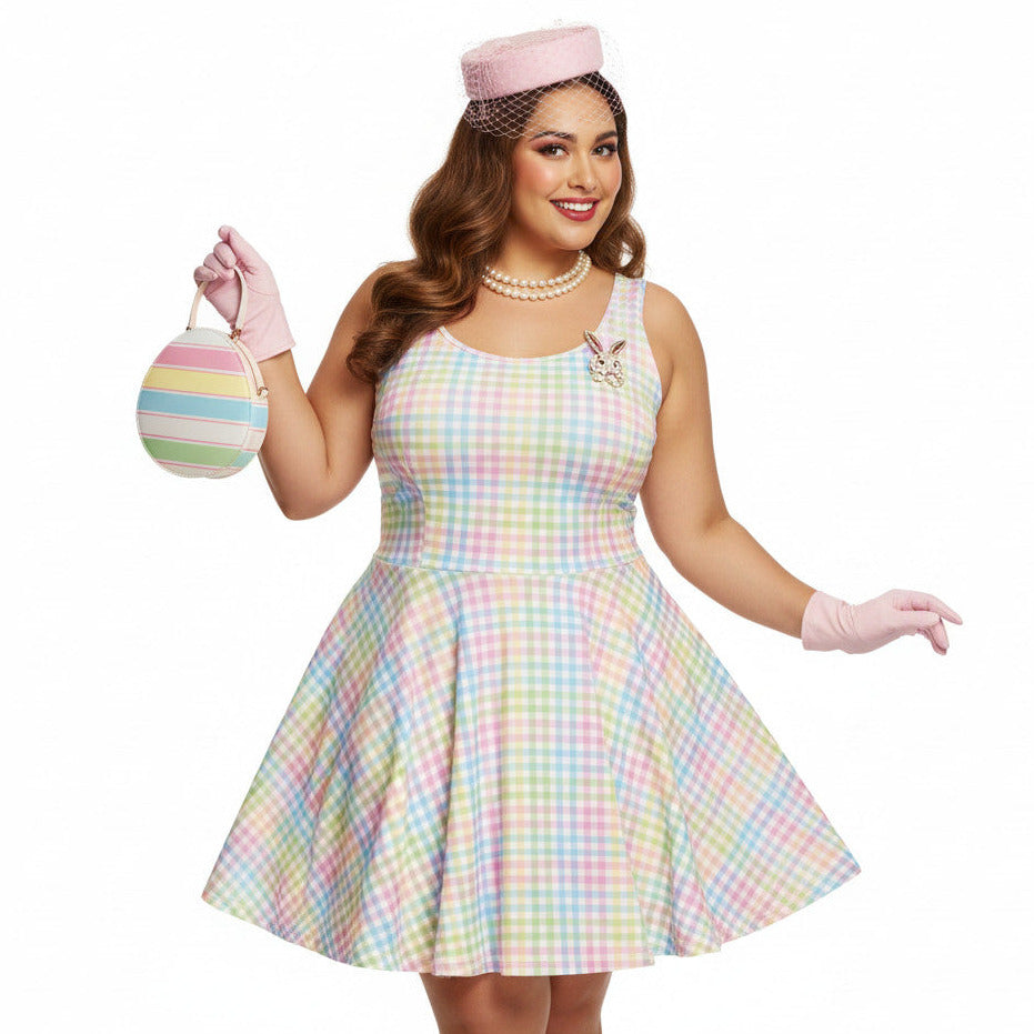Plus size woman wearing a pastel rainbow gingham 1950s vintage-inspired swing dress with a pink pillbox hat and pearl necklace.