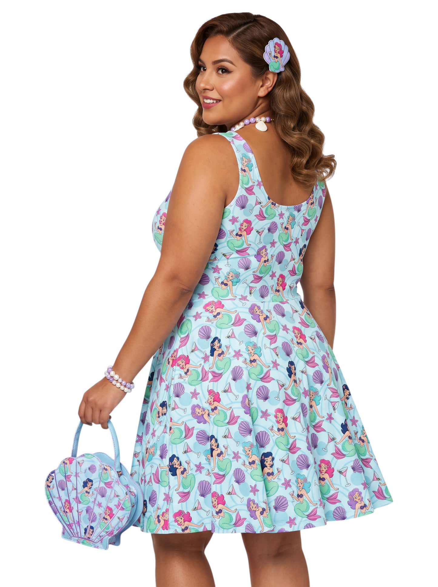 Curvy woman wearing a blue Mermaid and Martinis swing dress with a fit and flare silhouette.