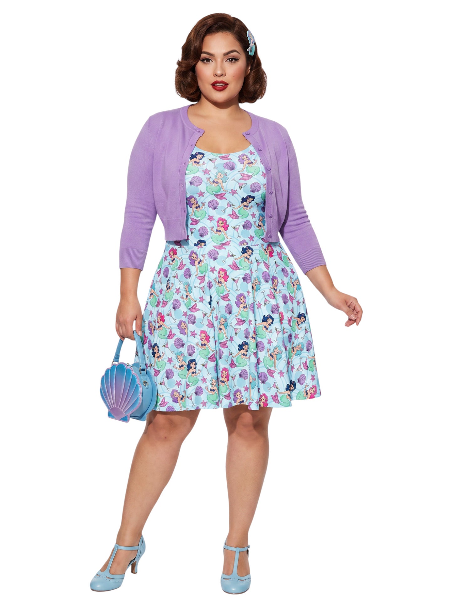 Curvy woman wearing a blue Mermaid and Martinis swing dress with a fit and flare silhouette.