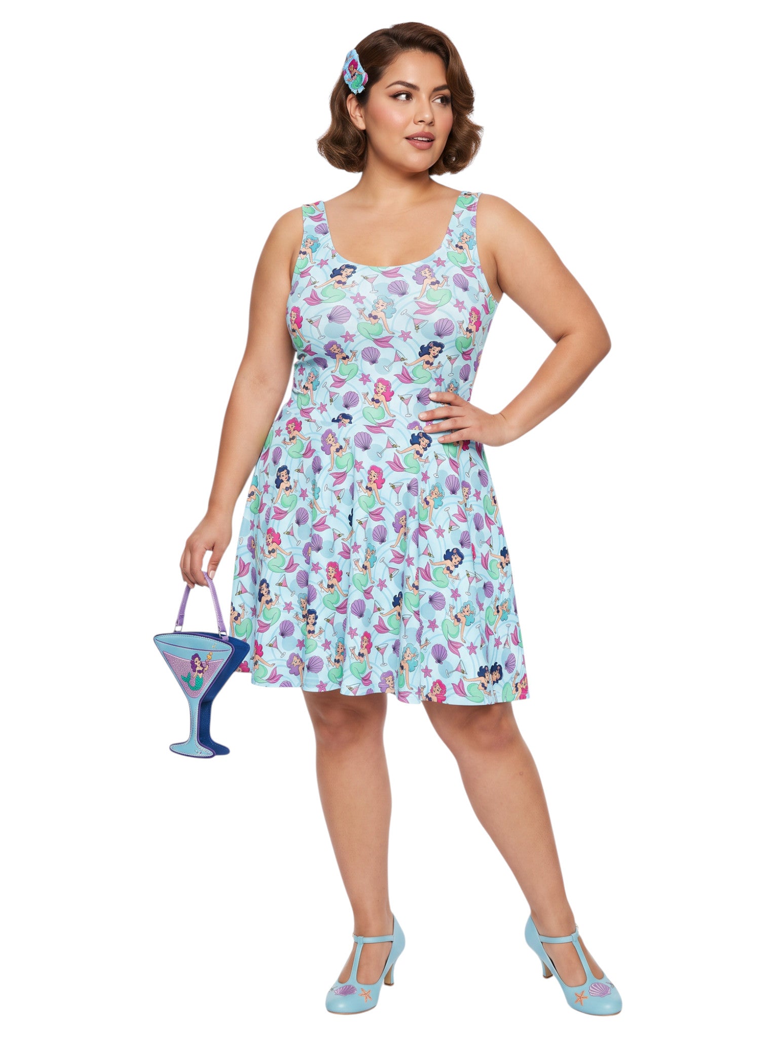 Curvy woman wearing a blue Mermaid and Martinis swing dress with a fit and flare silhouette.