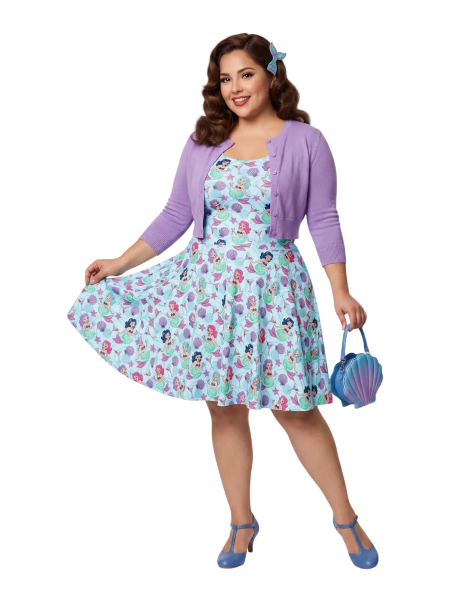 Curvy woman wearing a blue Mermaid and Martinis swing dress with a fit and flare silhouette.