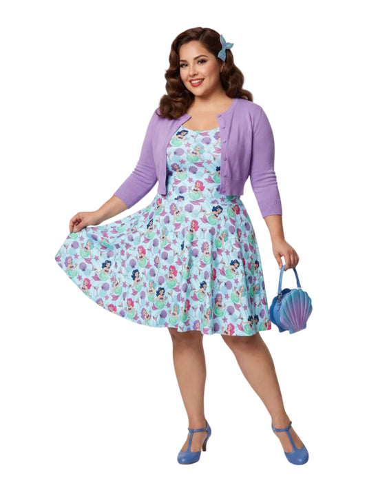 Curvy woman wearing a blue Mermaid and Martinis swing dress with a fit and flare silhouette.