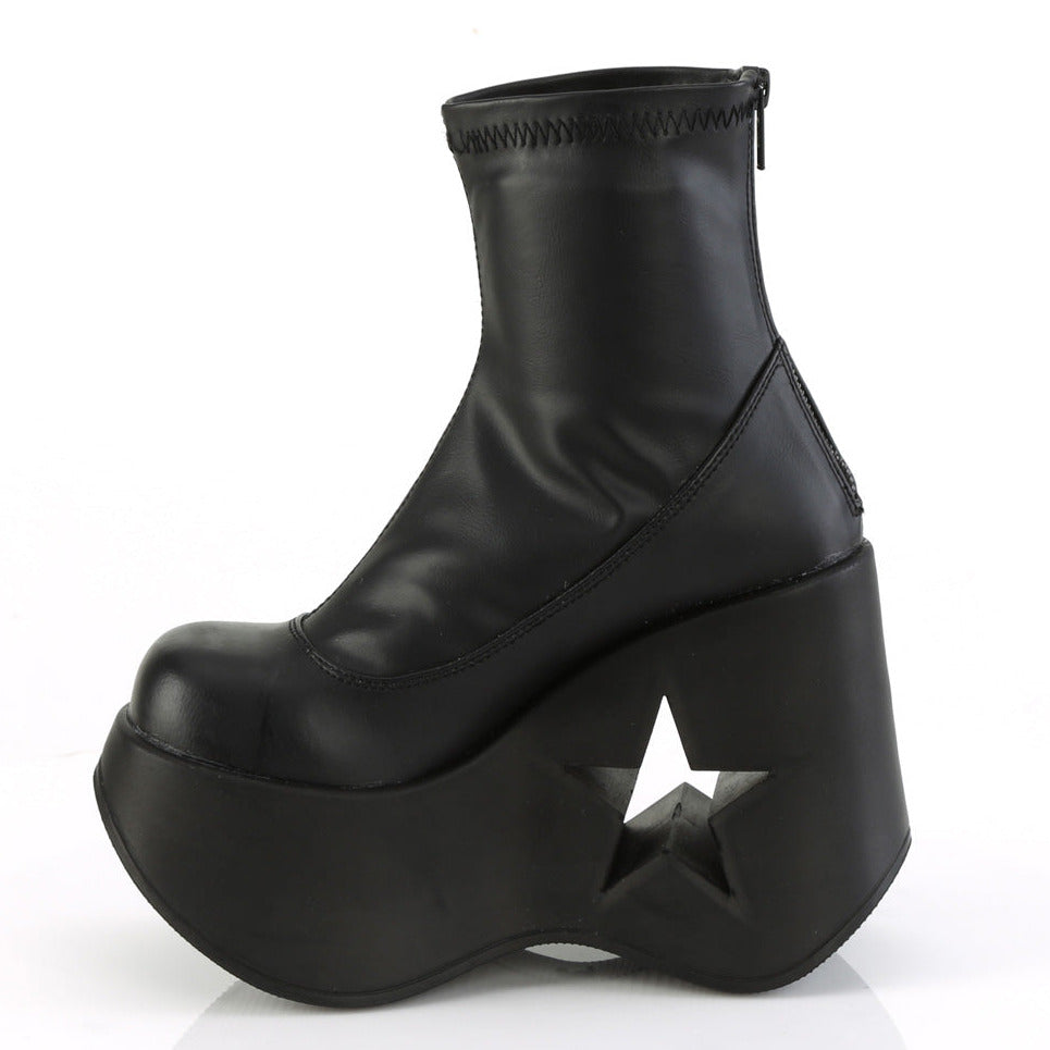 Black stretch faux leather platform wedge ankle boots for festivals with 5-inch star cutout heel and back metal zipper.