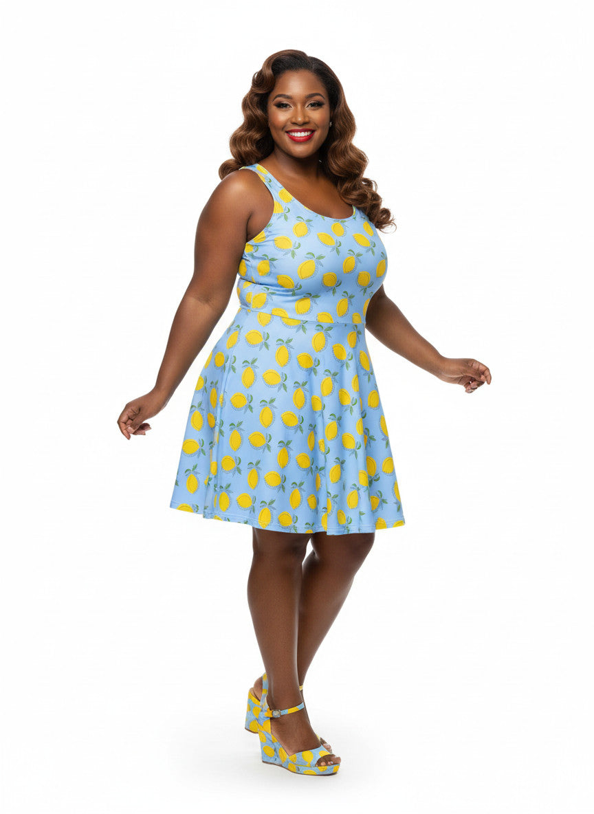 Plus size woman in blue lemon print vintage 50s swing dress with fit and flare silhouette.
