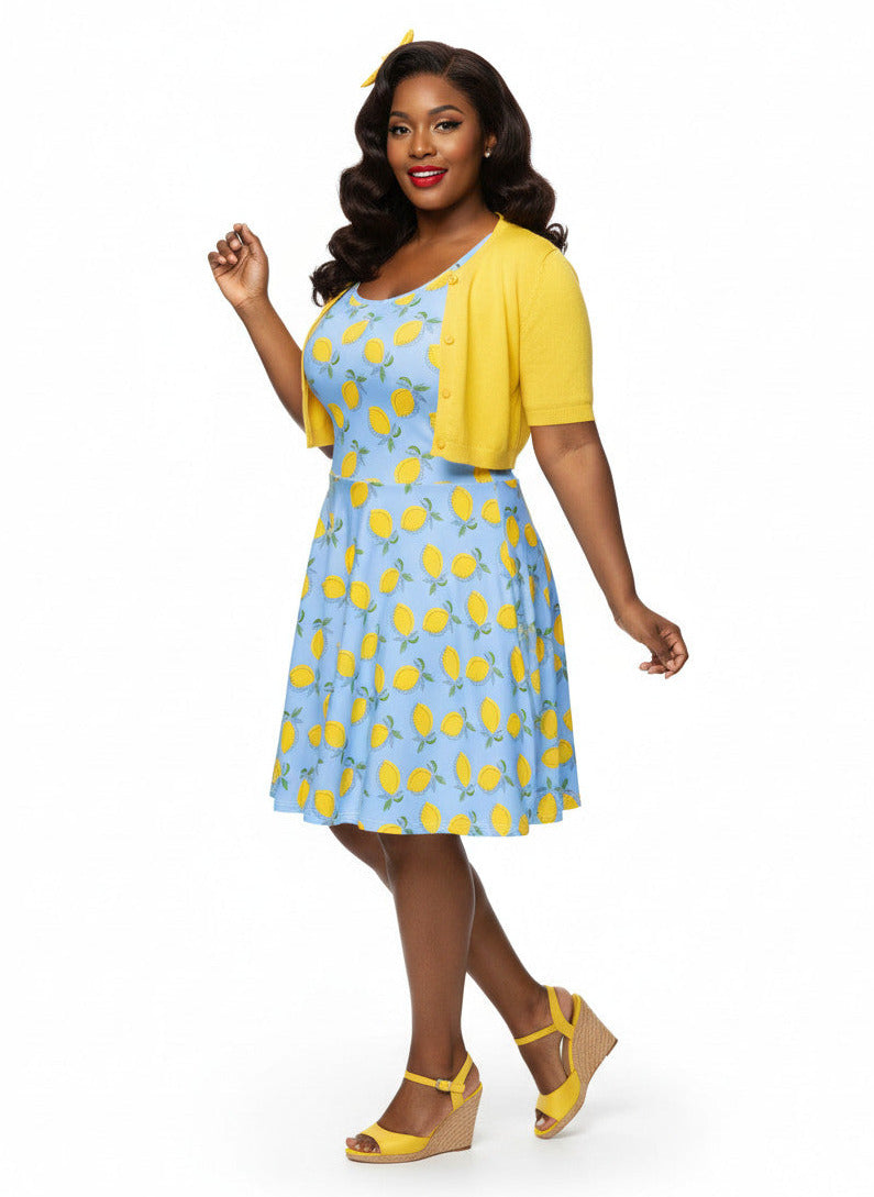 Woman in blue lemon print vintage 50s swing dress with fit and flare silhouette.