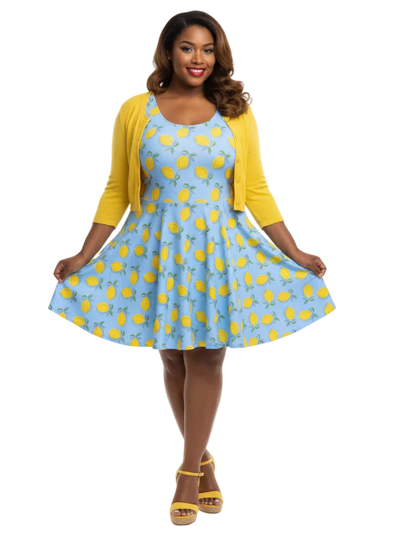 Woman in blue lemon print vintage 50s swing dress with fit and flare silhouette.