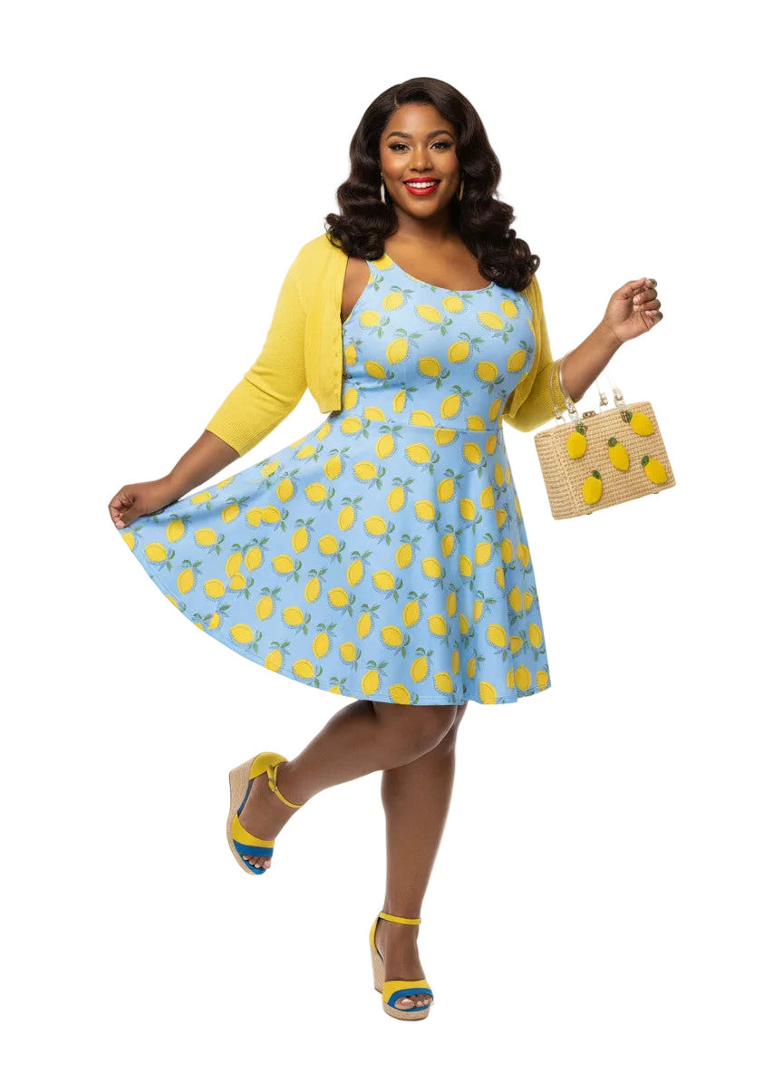 Model in blue lemon print vintage 50s swing dress with fit and flare plus size silhouette.