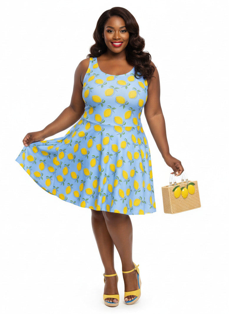 Plus size woman in blue lemon print vintage 50s swing dress with fit and flare silhouette.