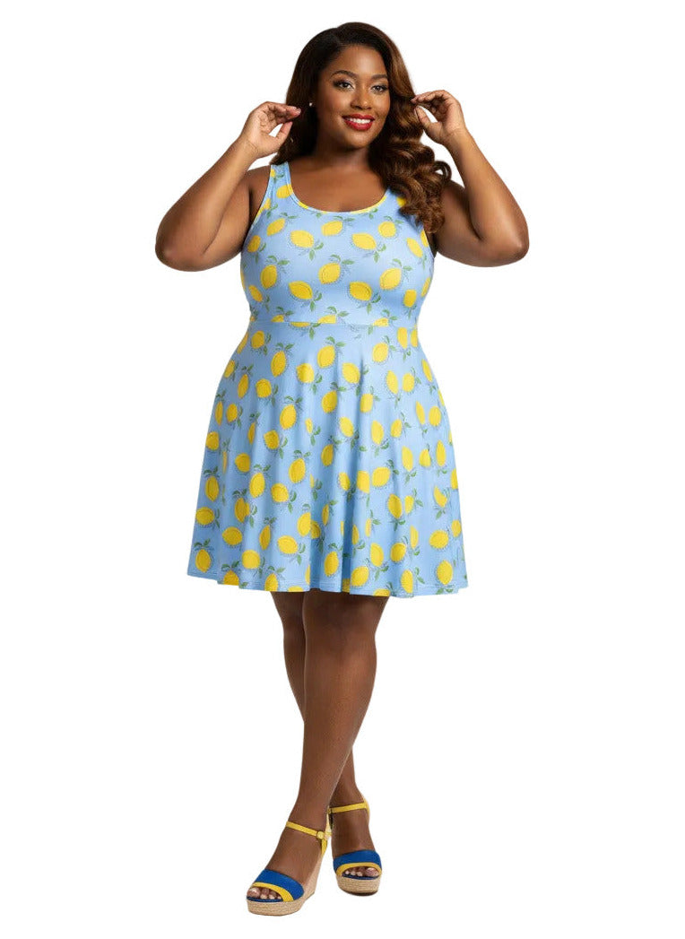 Plus size woman in blue lemon print vintage 50s swing dress with fit and flare silhouette.