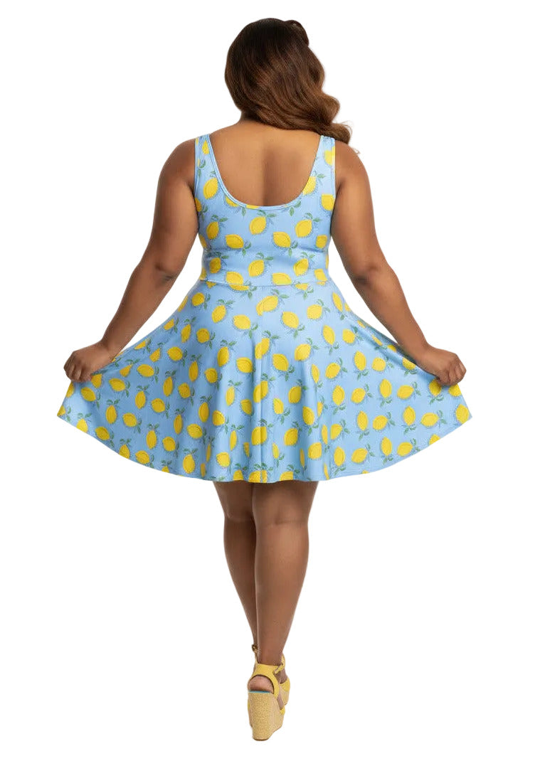 Plus size woman in blue lemon print vintage 50s swing dress with fit and flare silhouette.