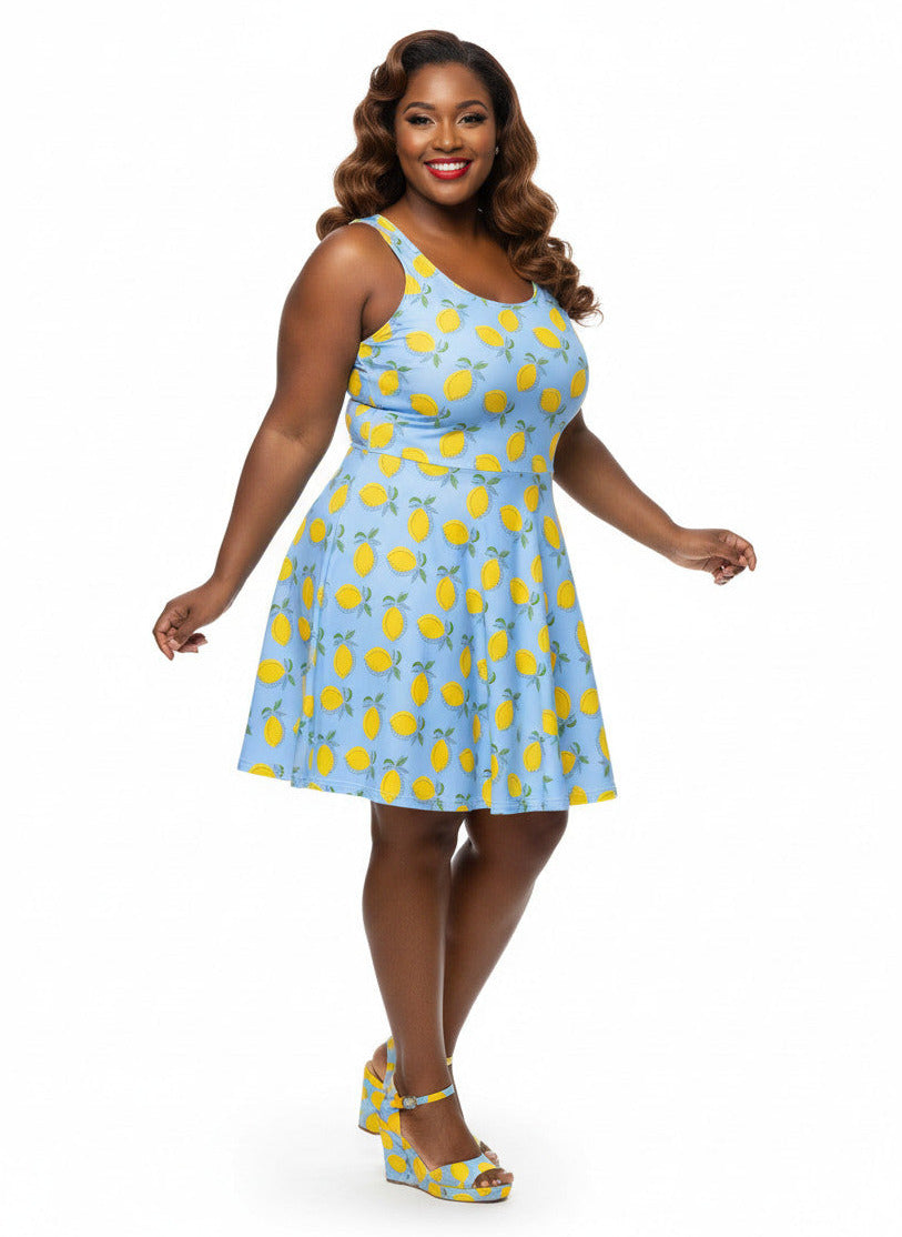 Plus size woman in blue lemon print vintage 50s swing dress with fit and flare silhouette.