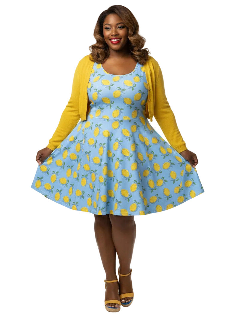 Plus size woman in blue lemon print vintage 50s swing dress with fit and flare silhouette.