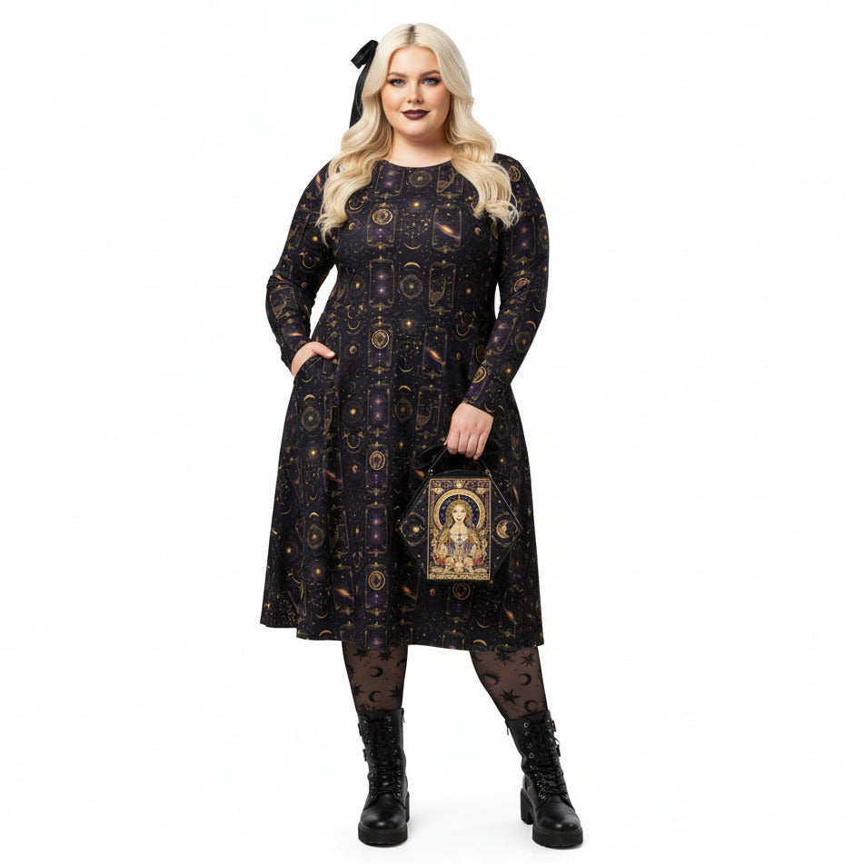 Woman wearing a celestial patterned dress holding a matching handbag on a white background