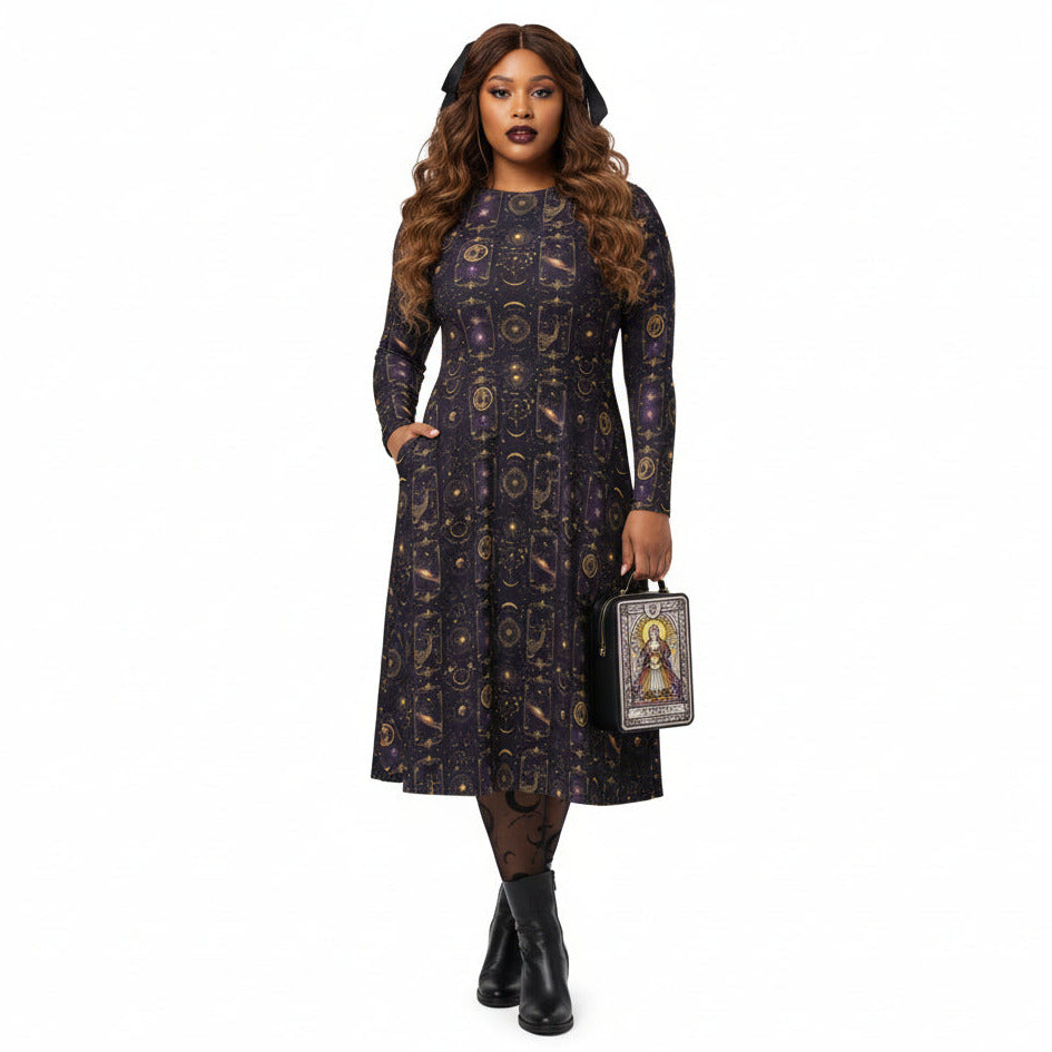 Woman wearing a celestial patterned dress holding a handbag on a white background