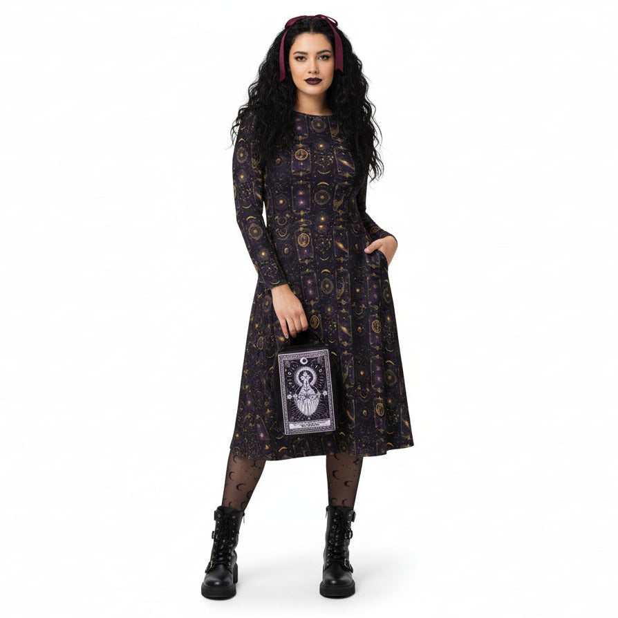 Woman wearing a celestial patterned dress holding tarot card bag on a white background