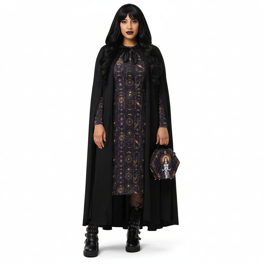 Woman wearing a black dress with celestial patterns and a matching cape on a white background