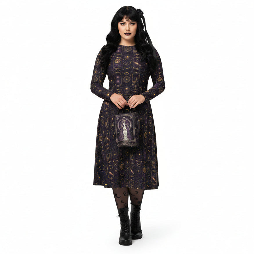 Woman wearing a dark patterned dress with a matching bag on a white background