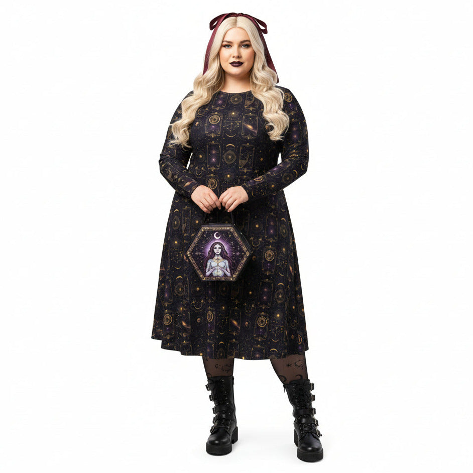 Woman wearing a dark celestial patterned dress with a hexagonal tarot card print bag on a white background
