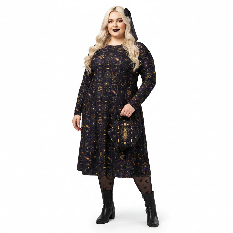 Woman wearing a black celestial dress with gold patterns on a white background