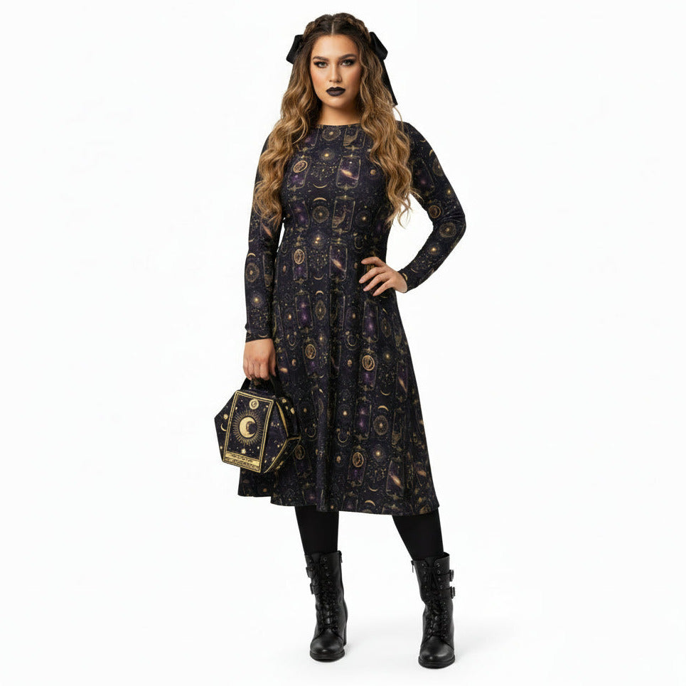 Woman wearing a black dress with celestial pattern and holding a matching bag on a white background