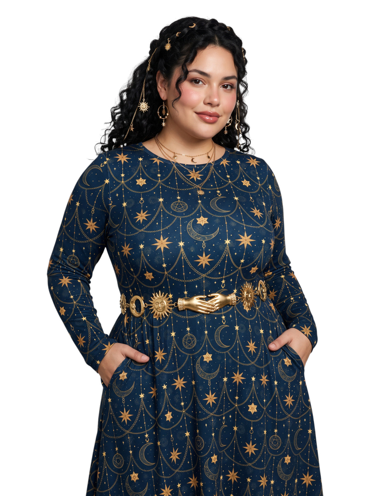 A woman modeling a long-sleeve navy blue dress with a gold celestial print of stars, moons, and suns, accessorized with a gold hand-shaped belt, against a plain white background.