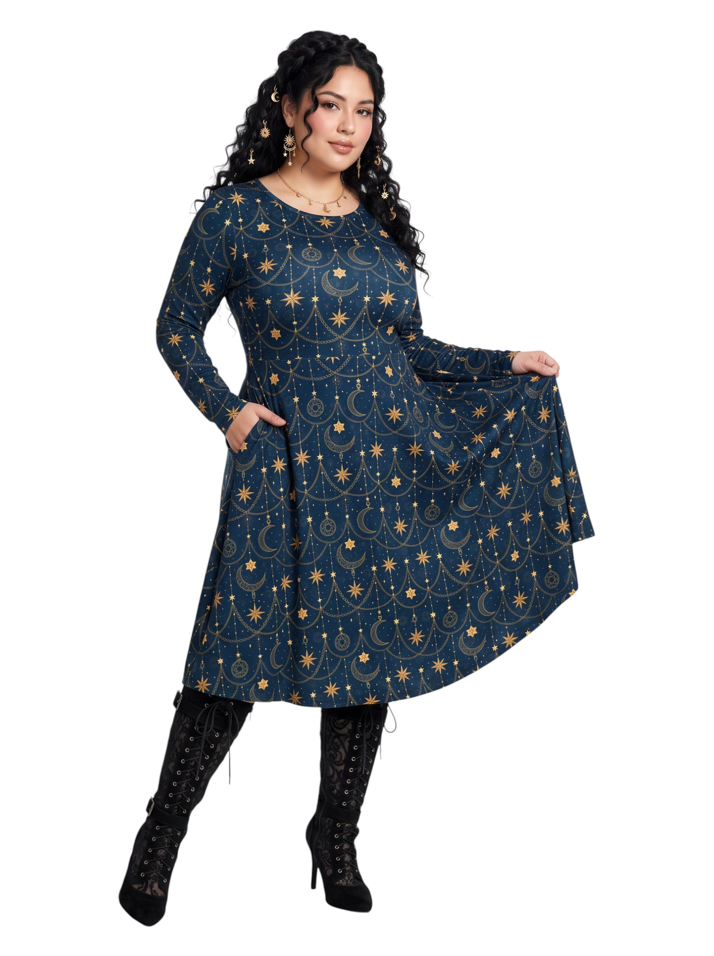 A woman modeling a long-sleeve A-line dress with a celestial print in navy blue and gold, paired with black lace-up heeled boots, against a plain white background.