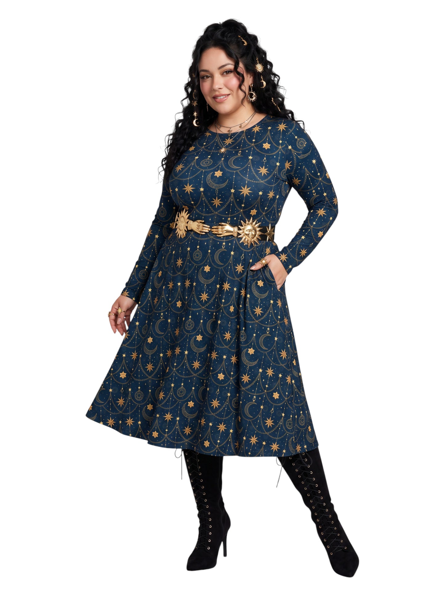 A woman modeling a long-sleeve navy blue dress with a gold celestial print of stars and crescent moons, styled with a wide gold belt and black lace-up boots against a plain white background.