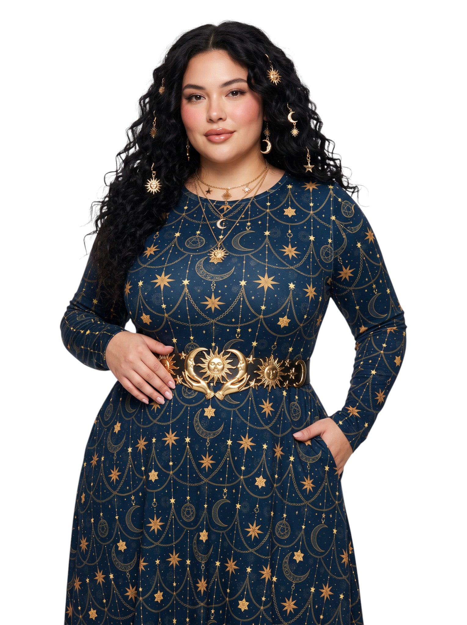 A woman modeling a long-sleeve navy blue dress with a gold celestial print of stars, moons, and suns, accessorized with a matching gold belt and gold jewelry against a plain white background.
