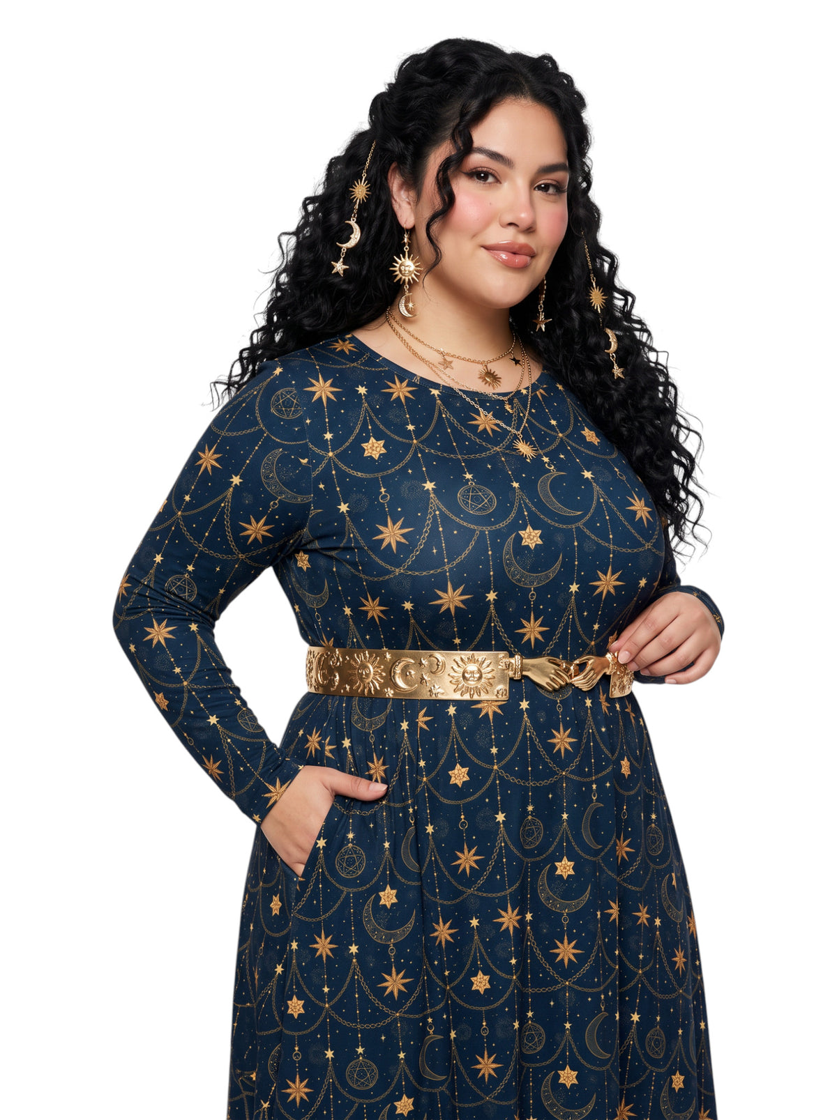A woman modeling a long-sleeve navy blue dress with a gold celestial print of stars, moons, and suns, accessorized with a wide gold belt, against a plain white background.